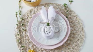 节日的复活节餐桌设置。 复活节餐桌装饰。 装饰师把桌子装饰到房间里。 妇女`